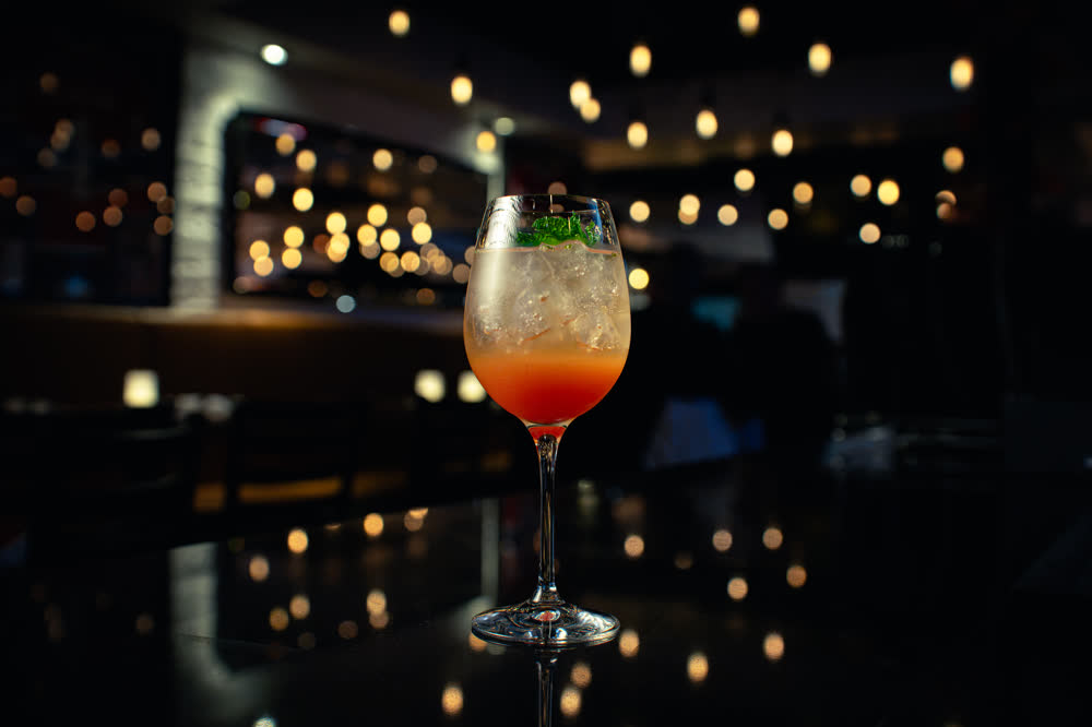 Orange spritz on a dark bar