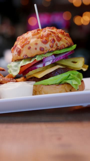 Burger and fries set down on the table